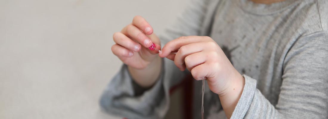 Student's hands using beads