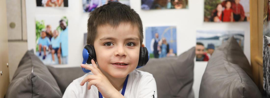 Student posing wearing headphones