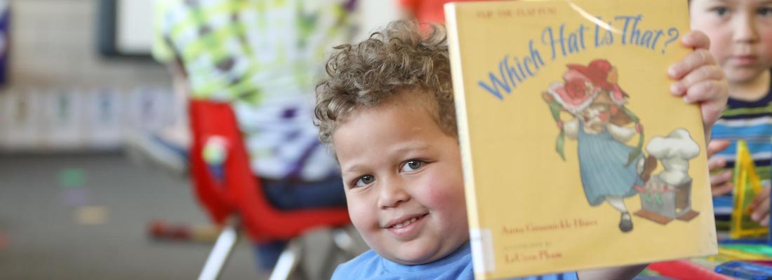 Student posing with a book