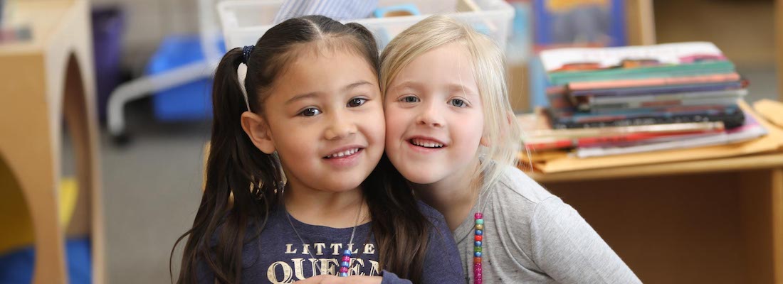 2 students posing in class