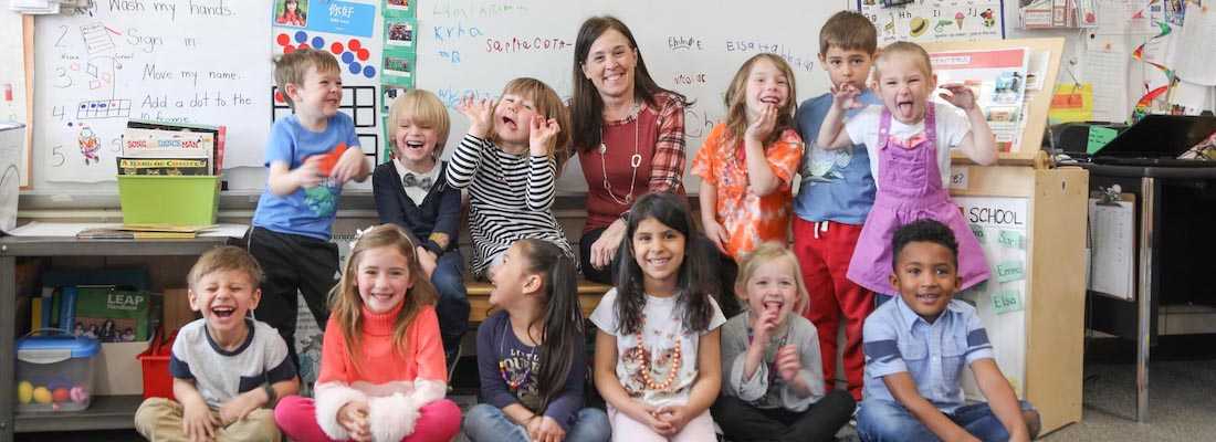 Class of students posing with teacher